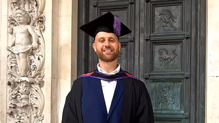Gareth Conlon in cap and gown after earning his first class Risk and Security Management degree